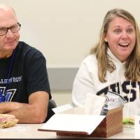 An alumna shares her experience as a Laker with an alumnus from the class of '68 listens.